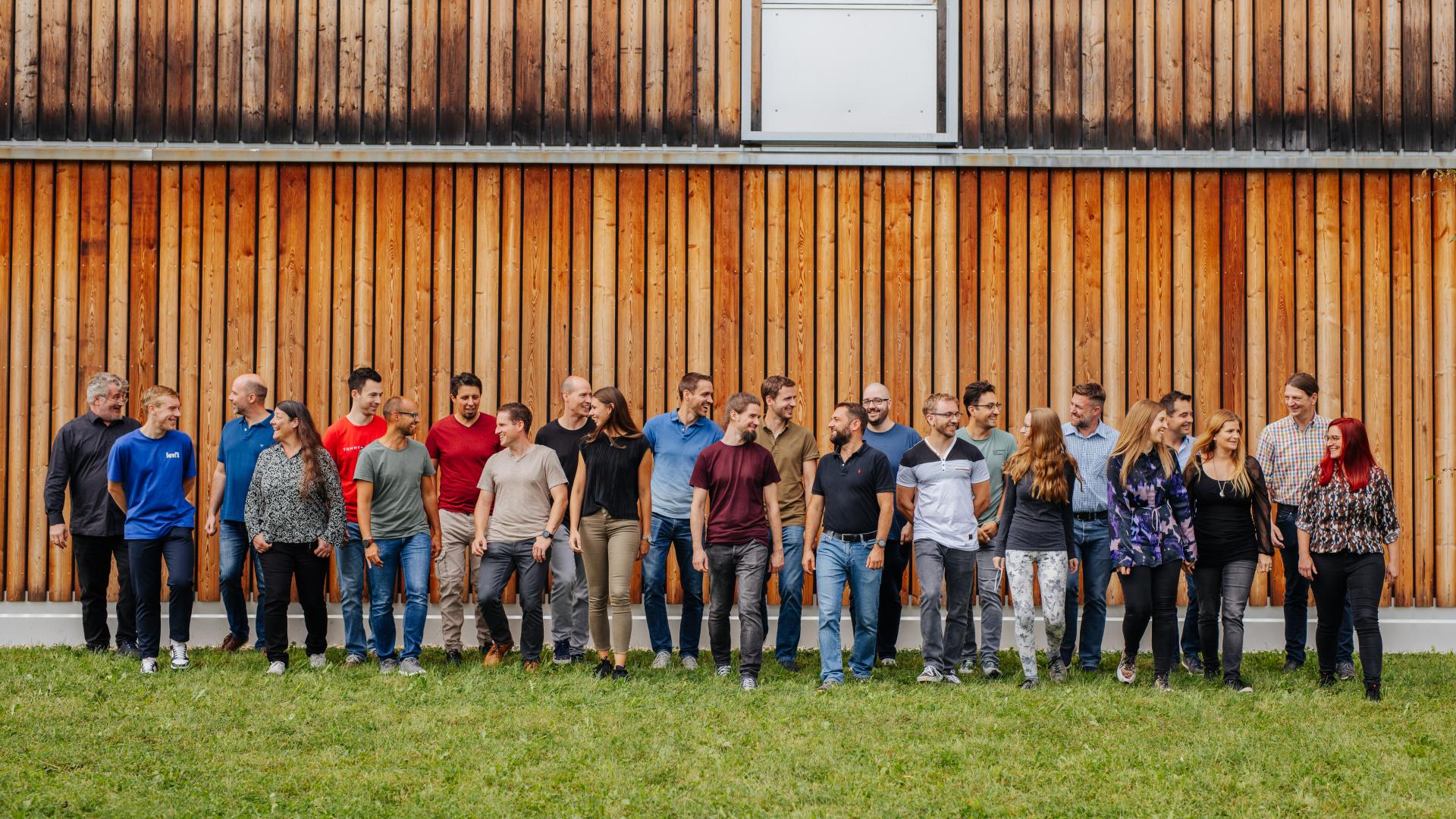 Gruppenaufnahme vor Holzfassade